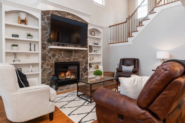 modern living room with custom fireplace and warm winter décor