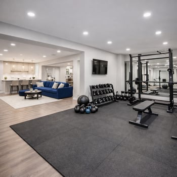 Finished basement home gym with workout equipment and open layout